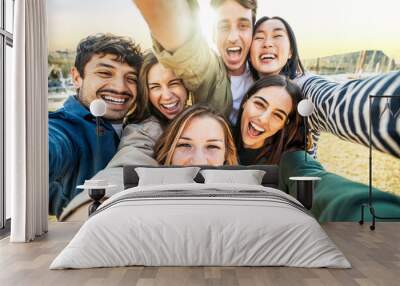 Multicultural group of friends taking selfie picture outside - Happy young people smiling at camera together - Friendship concept with guys and girls hanging in city street - Bright filter Wall mural