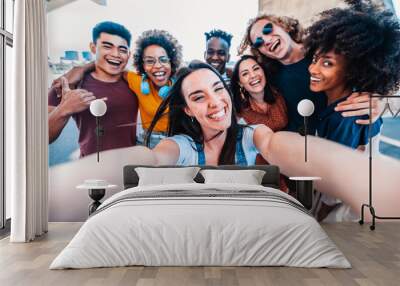 Multicultural happy friends having fun taking group selfie portrait on city street - Multiracial young people celebrating laughing together outdoors - Happy lifestyle concept Wall mural