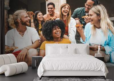 Multicultural smiling friends eating pizza sitting outside - Cheerful young people enjoying summer vacation together - Happy life style concept with guys and girls hanging out on a sunny day Wall mural