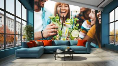 Multiracial friends enjoying happy hour toasting fresh mojito cocktails at open bar - Happy group of young people celebrating summer party together - Life style food and beverage concept Wall mural