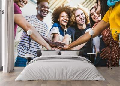 Multiracial happy young people stacking hands outside - Diverse friends unity togetherness in volunteer community - Concept about university, relationship, creative, youth and human resources Wall mural