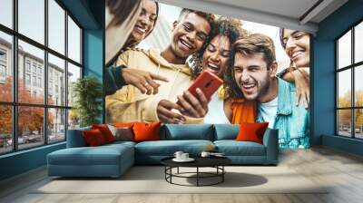 Multiracial young people using smart mobile phone device outdoors - Happy teenagers watching funny reel on smartphone - Technology life style concept Wall mural