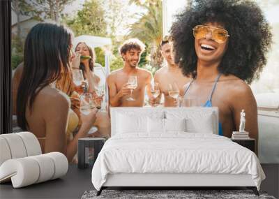 Portrait of group of young people having fun at pool party drinking champagne wine. Resort exclusive holiday concept Wall mural