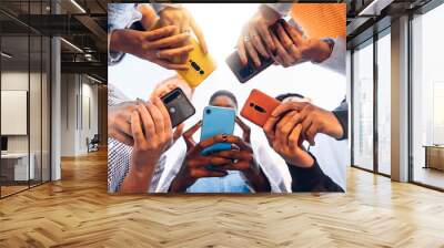 Teens in circle holding smart mobile phones - Multicultural young people using cellphones outside - Teenagers addicted to new technology concept Wall mural