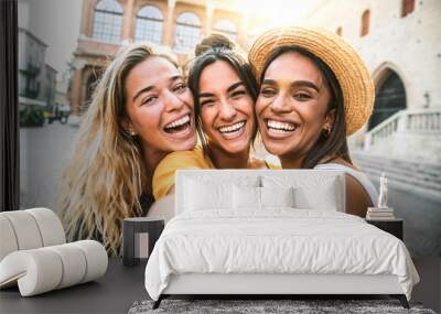 Three young women taking selfie portrait on city street - Multicultural female friends having fun on vacation hanging outdoor - Friendship and happy lifestyle concept Wall mural