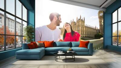 Young couple on vacation laughing and playing in front of the Big Ben - London - Caucasian people - Love, lifestyle, holiday and people concept  Wall mural