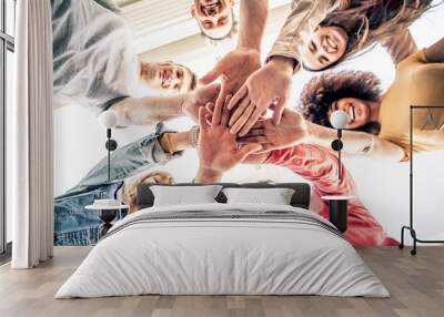 Young happy people stacking hands together outcoor - Community of multiracial international people supporting each other - Diverse culture Wall mural