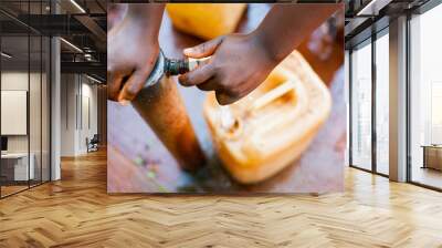 above close view up of young african child hand filling tank with tap water with green background Wall mural