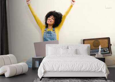 happy african woman at home using laptop, notebook, Wall mural