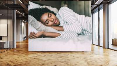 close up of a pretty black woman with curly hair sleeping in bed closed eyes Wall mural