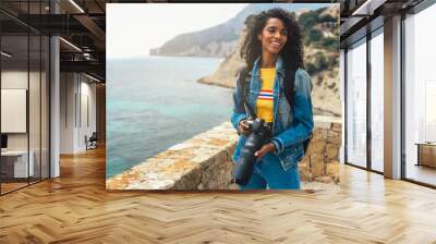 Photographer taking a picture of a ocean coast Wall mural