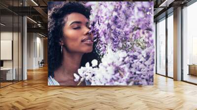 young black woman surrounded by flowers Wall mural