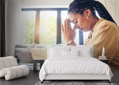 Bible, worship and woman praying in her living room for hope, help or forgiveness at home. Hands, book and Christian female in prayer for blessing, grace and gratitude to Jesus Christ or God in house Wall mural