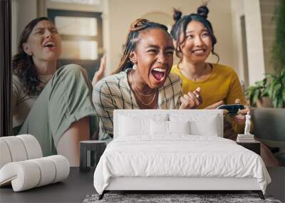 Friends, women and gaming on tv, winner in home living room on sofa and smile, relax and bonding. Television, girls and celebration on video game success on couch, esports competition and excited Wall mural