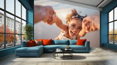 Girl child, spin and pov by ocean, portrait and smile for game, holding hands or speed in summer. Young female kid, parent and swing in air, sand or happy for family bonding, love or care in sunshine Wall mural