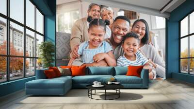 Portrait, smile and big family in home with kids, grandma and grandfather bonding in living room. Face, mother and father hug children, happy grandparents and generations laughing together for love Wall mural