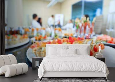 Catering in the office. A table with canapes and various snacks served  on the background of a business meeting. Wall mural