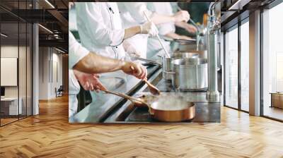 Chef cooking vegetables in wok pan. Shallow dof. Wall mural