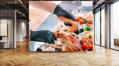 The Chef puts the seafood on a tray in the restaurant. Wall mural