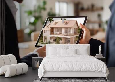 A realtor holds a tablet showing a virtual house tour to a young couple interested in buying a home Wall mural