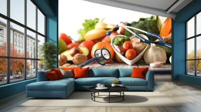 Healthy food concept with fruits and vegetables and stethoscope front Wall mural