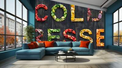 Cold pressed juice vegetables words spelled out with healthy organic fruit on rustic background Wall mural