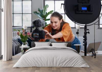 Online content creator vlogger adjusting her recording equipment Wall mural