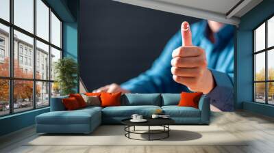 vote, feedback, quality, voting, information, approval, achievement, thumb, satisfaction, agree. A man is giving a thumbs up on a laptop. The image conveys a positive and happy mood. Wall mural