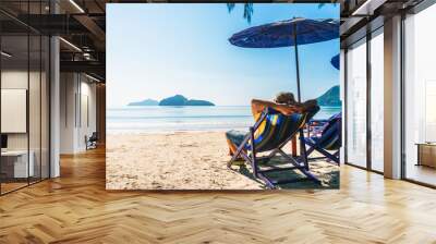 Summer lifestyle Asian man traveler relaxing on beach chair in front of vacation exotic beach, Attraction place leisure tourist travel Hua Hin Thailand holiday trip, Tourism beautiful destination Asia Wall mural