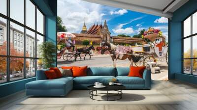 Tradition horse drawn retro carriage for traveler in front of Wat Phra That Lampang Luang, Attraction famous landmark tourist travel Lampang Thailand vacation trip, Tourism beautiful destinations Asia Wall mural