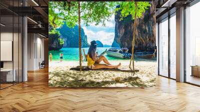 Traveler woman in bikini sitting on swing using tablet on tropical beach Lao Lading island Krabi, Leisure tourist travel Phuket Thailand Summer holiday vacation, Tourism beautiful destination Asia Wall mural