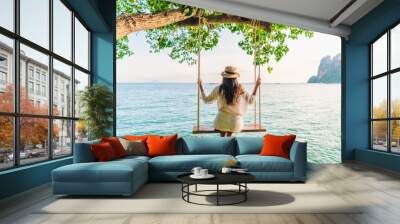 Traveler woman relaxing on swing above Andaman sea Railay beach Krabi, Leisure tourist travel Phuket Thailand summer holiday vacation trip, Beautiful destinations place Asia, Happy dream concept Wall mural