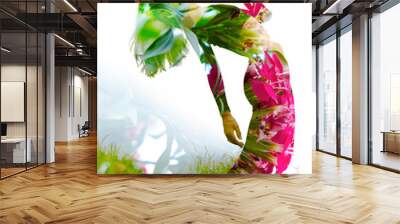 Double exposure of an elegant girl leaning back combined with photograph of bright tropical plants with vibrant flowers Wall mural