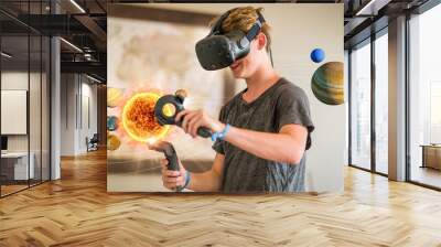 A teenage student wearing a virtual reality headset to study science. Wall mural