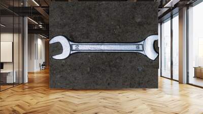 Shining broken wrench. Work tool failure On cement floor Wall mural