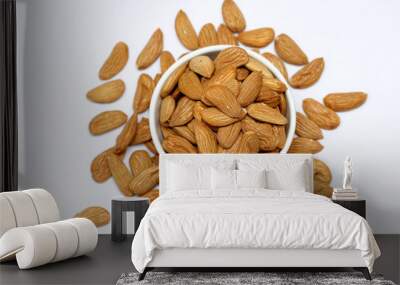 Almond mamra giri isolated. Group of almond nuts isolated on white background. Full depth of field Wall mural