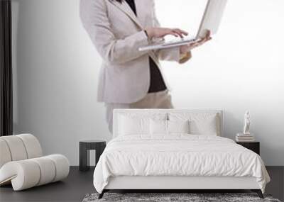 Businesswoman working on a laptop isolated over white full body Wall mural