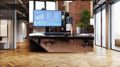 close up of computer with company data analysis on desk in empty office. monitor with business diagr Wall mural