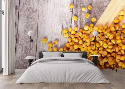 Close up of Roasted corn on wooden background in studio photo. Delicious salty roasted corn Wall mural