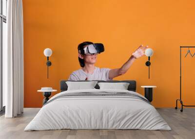 Man playing virtual reality games in vr goggles, exploring metaverse. Person wearing ar headset enjoying videogames, simulation experience, touching objects in cyberspace Wall mural