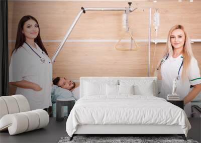 Patient in hospital room next to two nurses. Medical and healthcare Wall mural