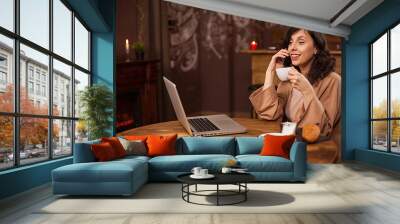 Portrait of caucasian young business woman with computer in a coffee shop Wall mural