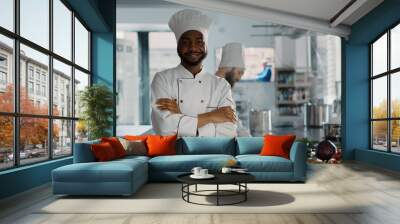 Portrait of confident man working as chef in gourmet kitchen, cooking restaurant dish with organic food. Young cook making gastronomy meal with delicious culinary recipe. Handheld shot. Wall mural