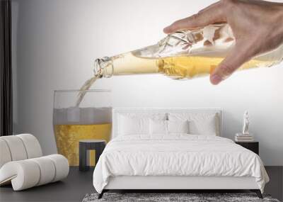 Beer pouring into glass on a gray gradient background. Wall mural