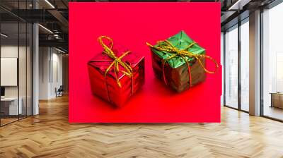 Two gift boxes on red background Wall mural