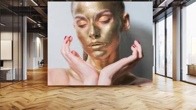 gold make-up face mask, closeup healthy young woman gold Wall mural