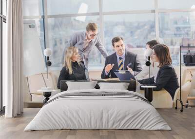 Group of successful business partners in casual communicating at meeting in office Wall mural