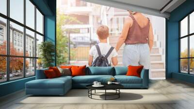 mom prepares the boy's son for school Wall mural