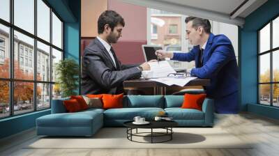 two businessman business partner are negotiating in the cafe Wall mural