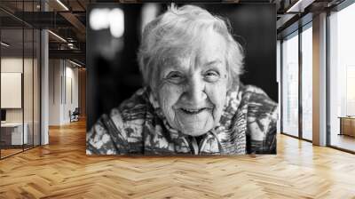 Close-up of black and white portrait of an elderly woman. Wall mural